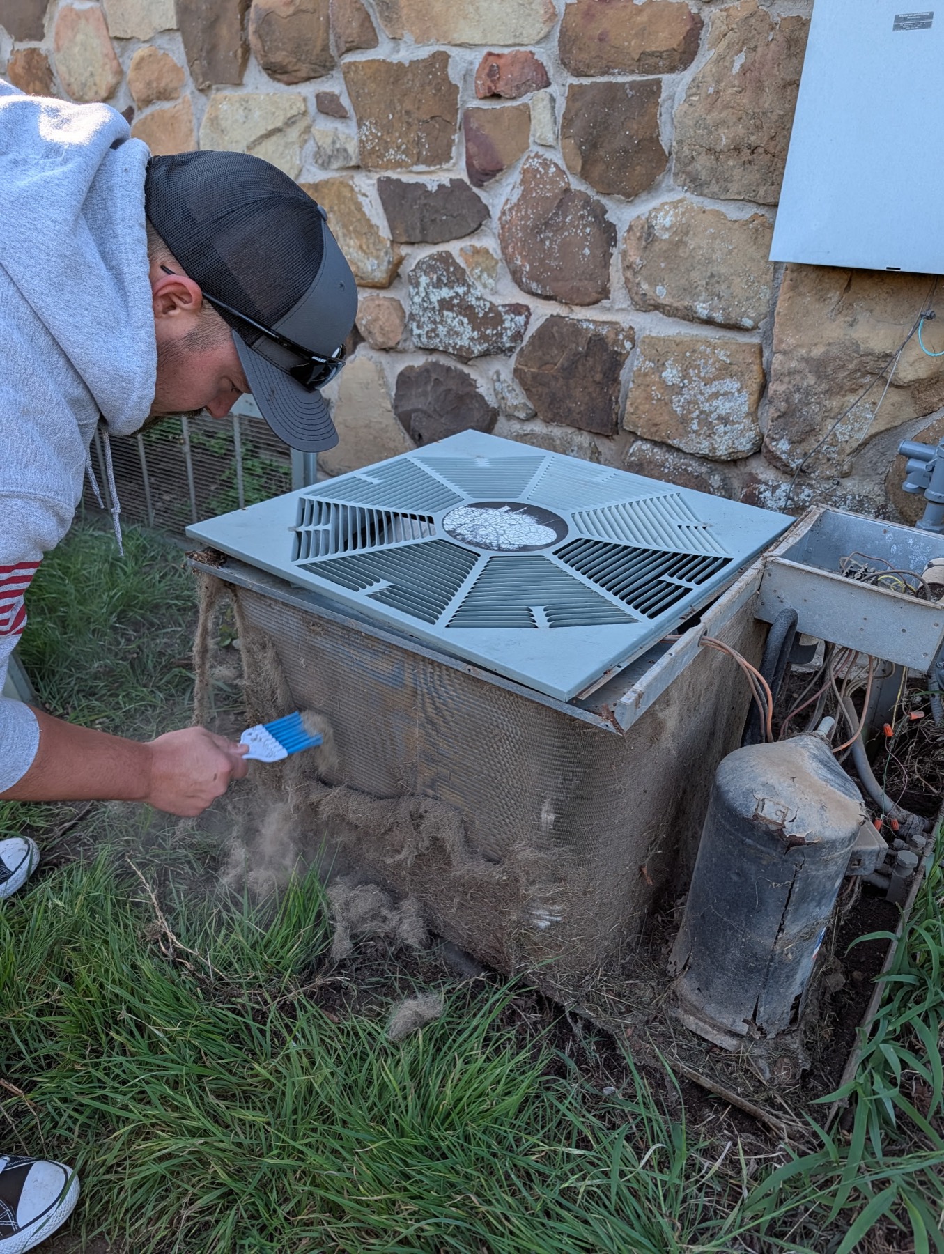 EZ Heating and Cooling technician deep-cleaning a condenser coil