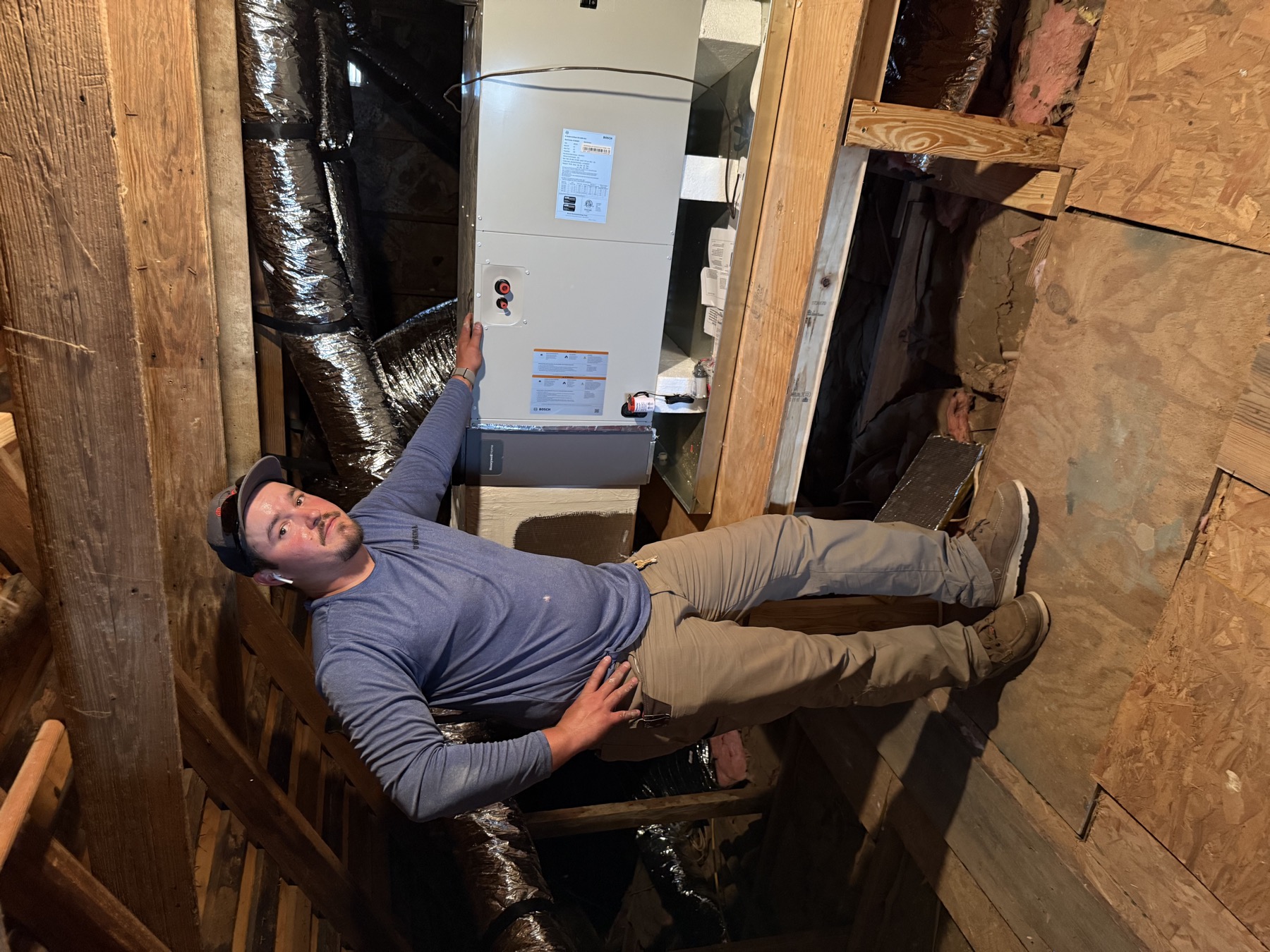 EZ Heating and Cooling technician with a newly installed attic unit
