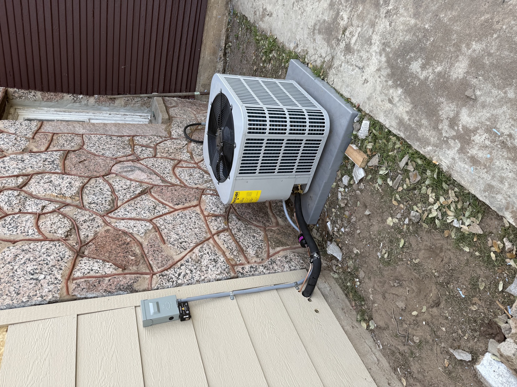 Condenser installed at a stone home near Clover, SC by EZ Heating and Cooling