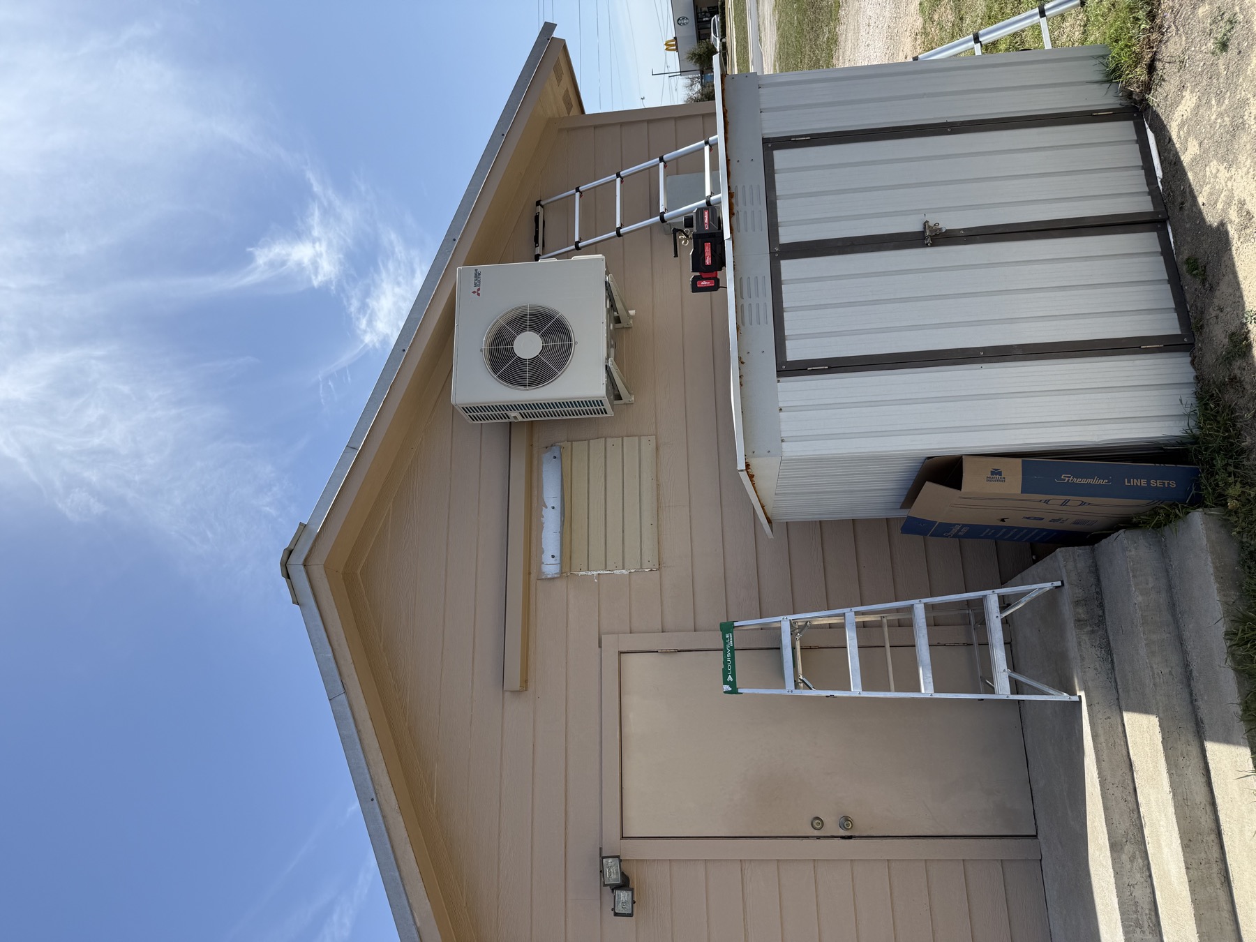 Air conditioner condenser installed at a Rock Hill area stone home by EZ Heating and Cooling