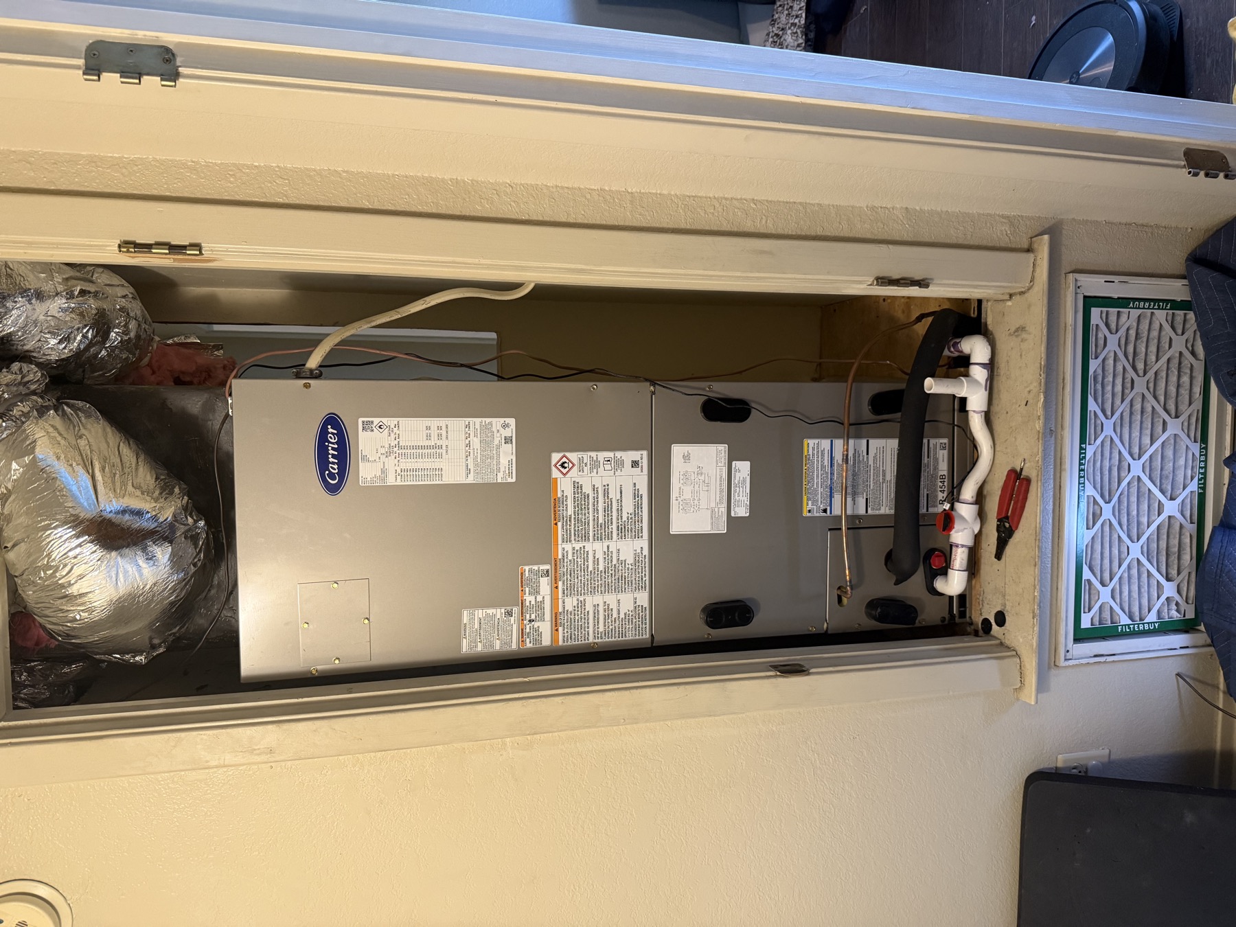 Carrier air handler installed in a hallway closet with new filter rack