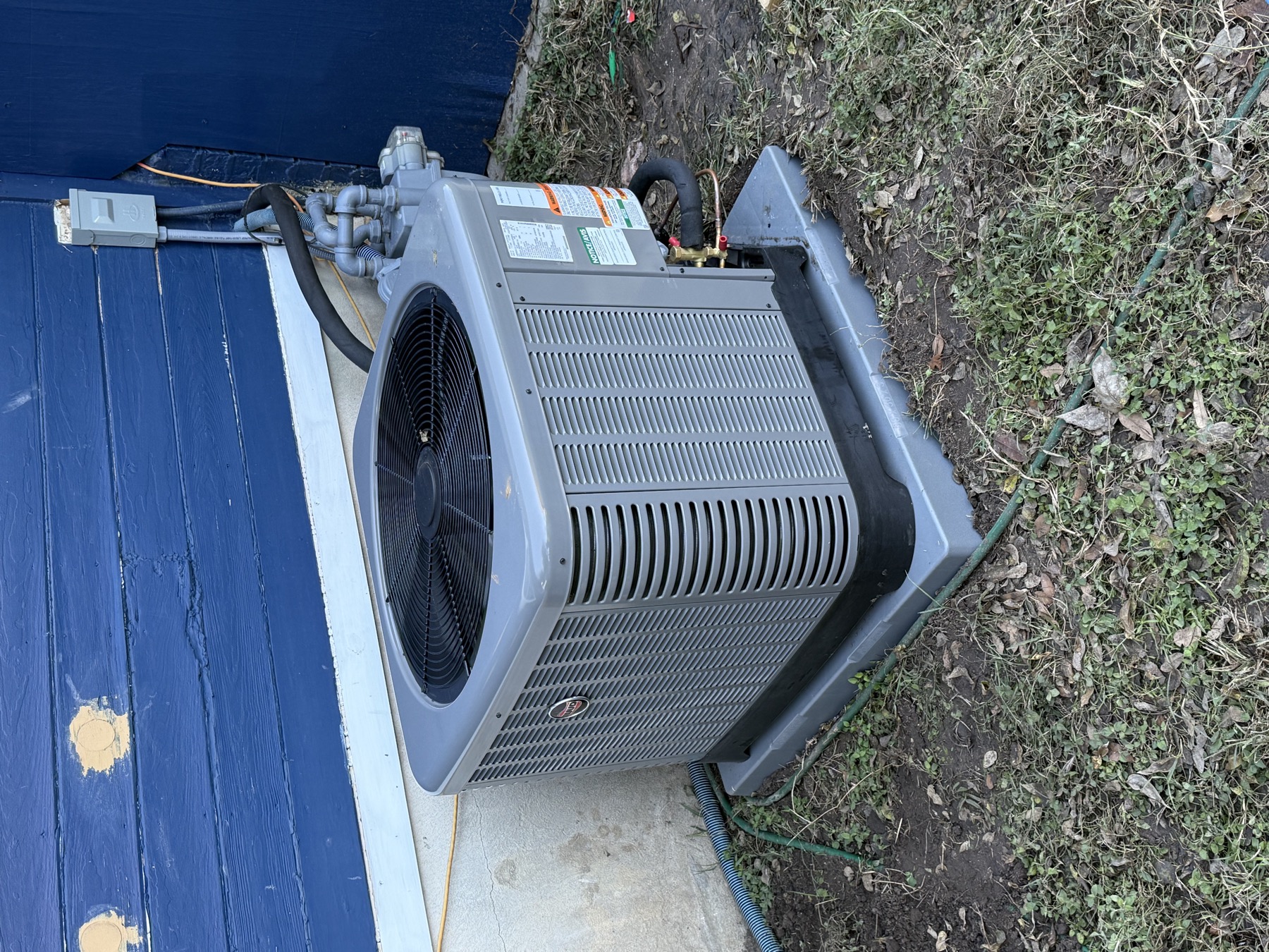 New Rheem air conditioner condenser installed on a fresh pad by EZ Heating and Cooling