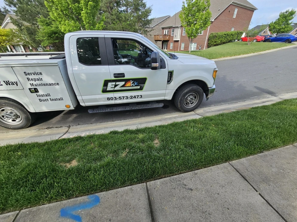 EZ Heating and Cooling service truck with phone number on the door