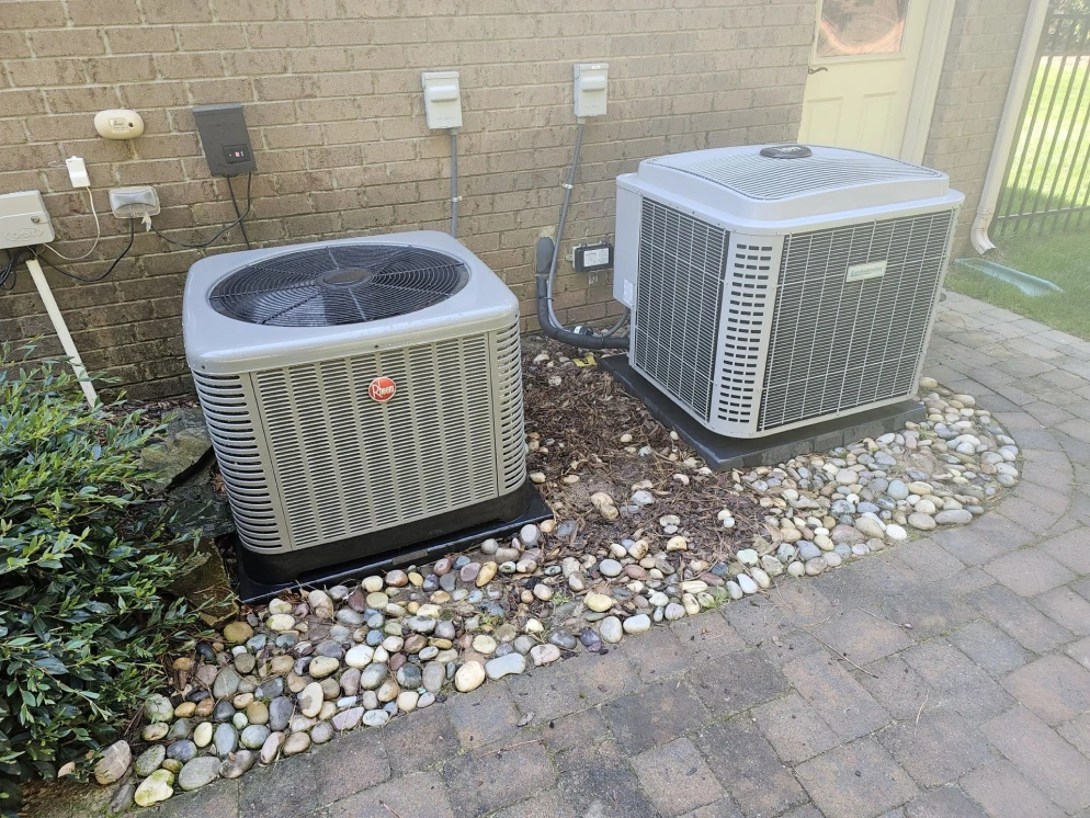 Two condensers installed on paver pads at a Tega Cay area home by EZ Heating and Cooling
